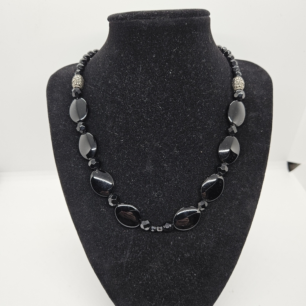 black glass beaded necklace with silver tone flower barrel beads
